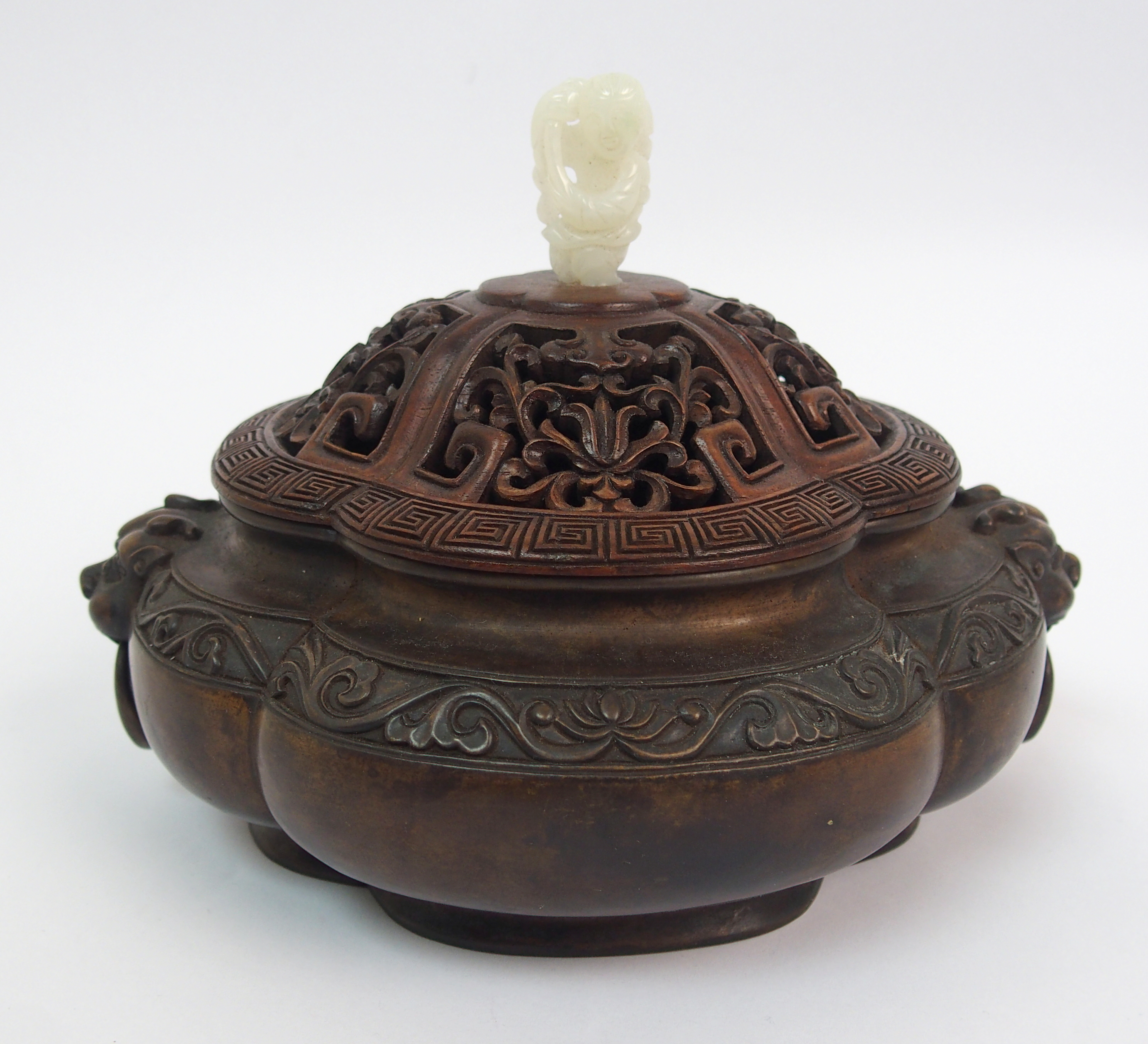 A Chinese bronze censer of quatrefoil lobed form, the shaped rim above a band of lotus and flanked