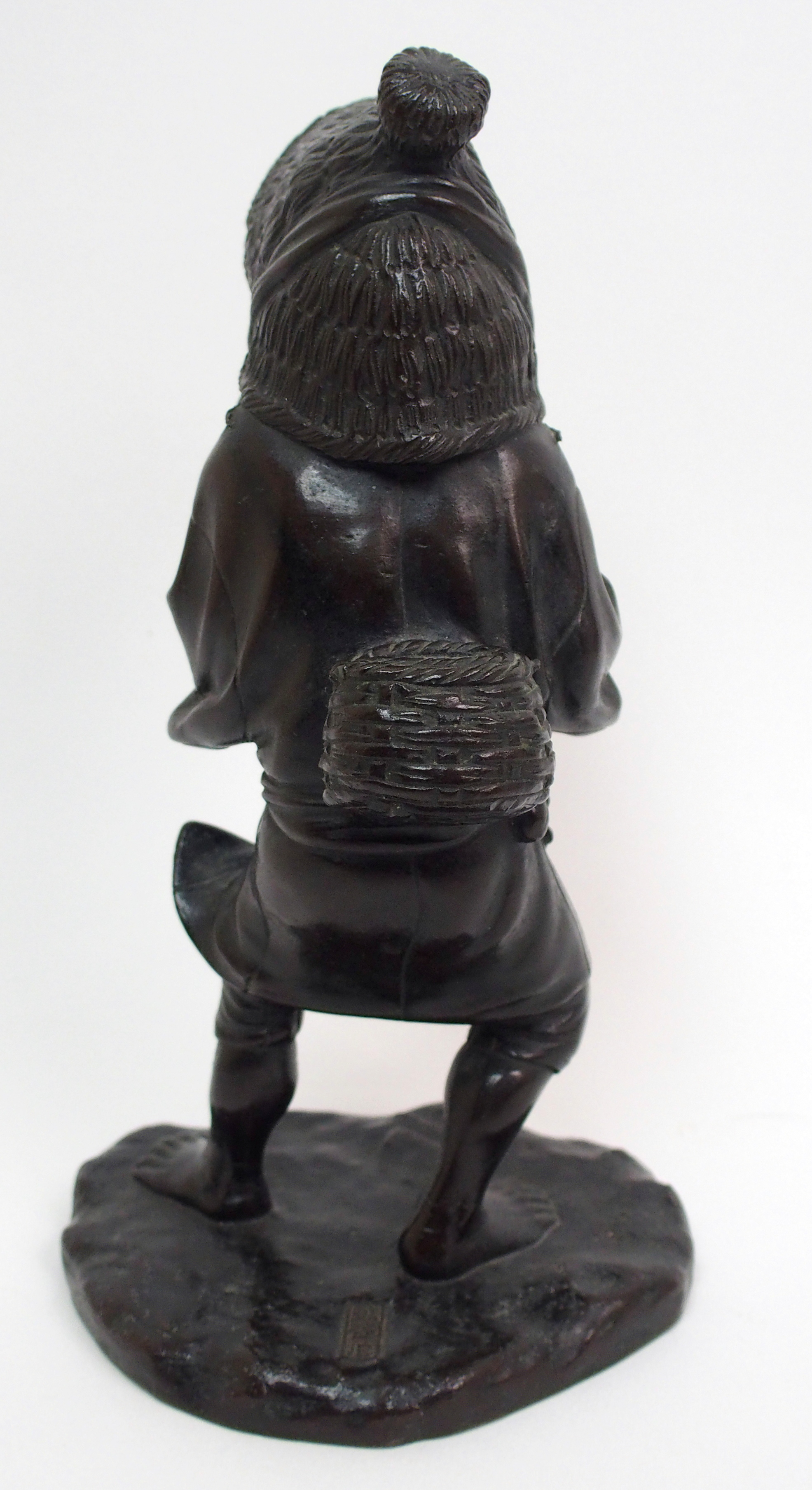 A Japanese bronze figure of a worker standing and holding straw hat around her head and on a mound - Image 5 of 8