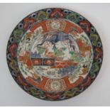 An Imari shallow bowl painted with Ho-o birds in fenced garden within flower head medallions, 38cm