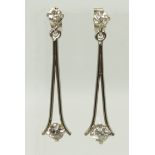 A pair of white metal diamond drop earrings hallmarked 18ct gold to the butterfly backs, a diamond