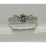 An 18ct white gold and platinum three stone diamond ring in classic crown mounts total diamond