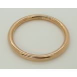 A 9ct rose gold slave bangle made by Saunders & Shepherd inner diameter 7.6cm, outer diameter 9.2cm,