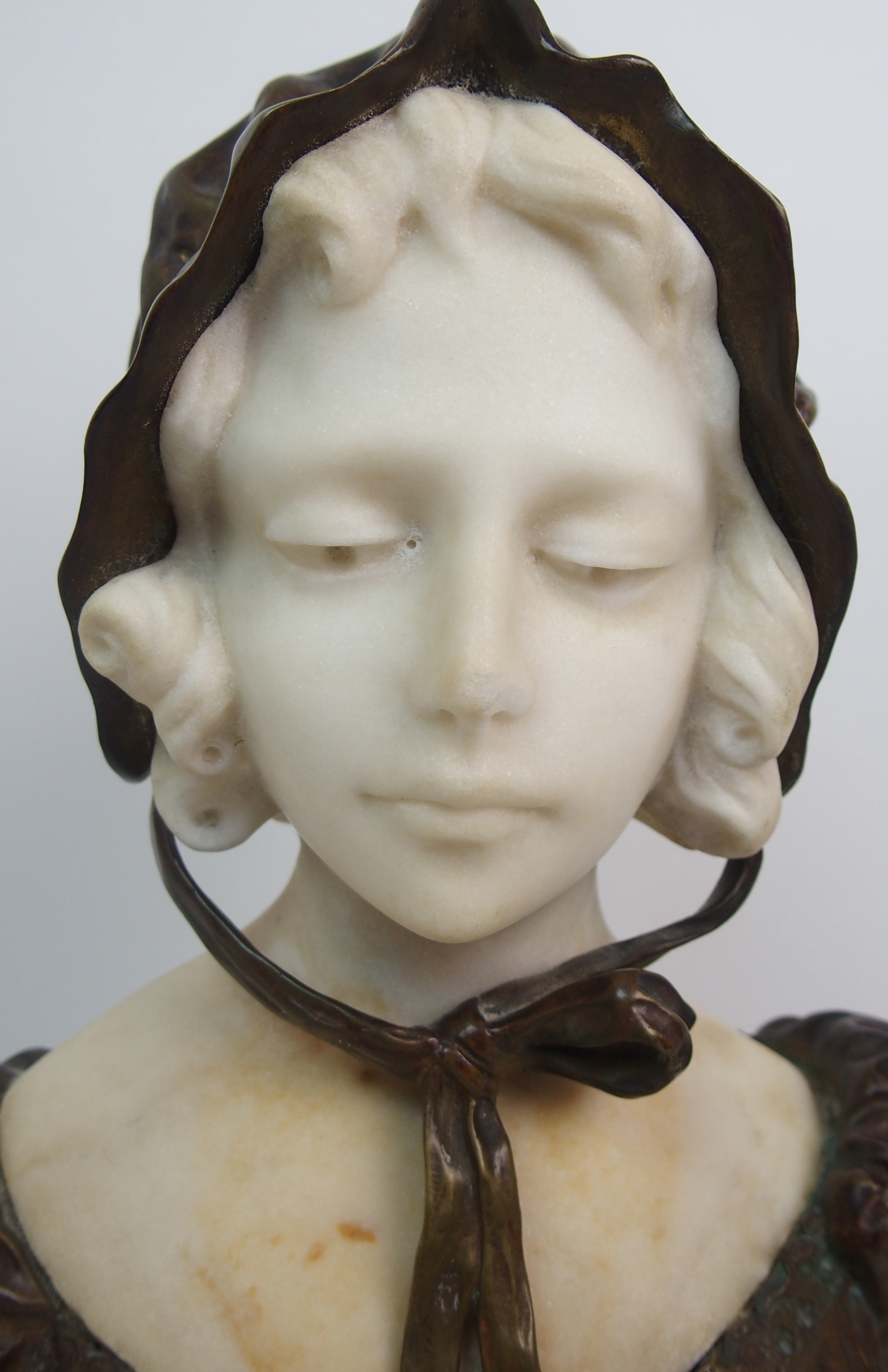 Affortunato Gory (active 1895-1925) Bronze and alabaster bust of a girl modelled wearing a bonnet, - Image 2 of 10