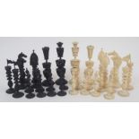 An early carved chess set complete, in fitted case