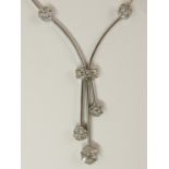 A 14ct gold diamond flower necklace the pretty design has diamond set flowers along its length, with