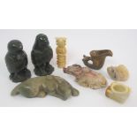 A group of hard stone carvings comprising; feline, 14cm wide, buffalo, 9.5cm wide, rhyton cup, 5cm
