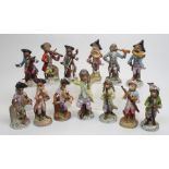 A Dresden thirteen piece monkey band after the Meissen originals, on gilt scrolled bases of