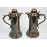 A large pair of late Victorian EPNS wine flagons with domed hinged lids each inscribed with initials