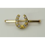 A 9ct gold diamond set horseshoe brooch estimated approx diamond content 0.94cts, dimensions 5cm x