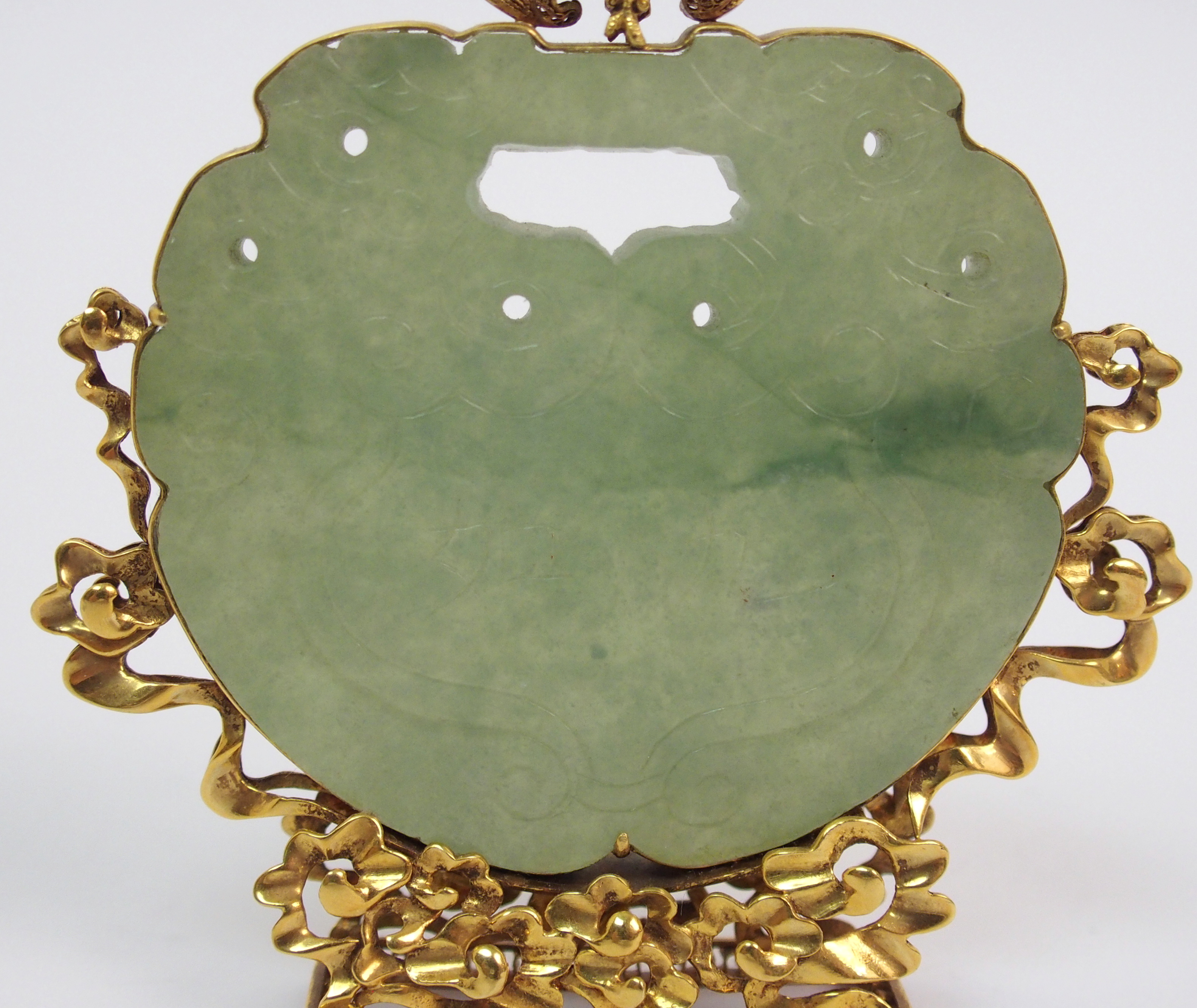 A Chinese hardstone pendant disc carving with conjoined grotesques, set within a gilt metal - Image 4 of 10