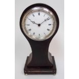 An Edwardian tortoiseshell mantle clock of balloon shape with silver plated mounts and inlay, upon