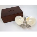 A Chinese silver butterfly stand with mother of pearl shell wings and standing on six legs,