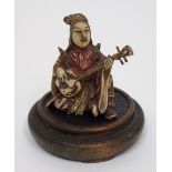 A Chinese polychrome figure carved as a female musician playing a Dan Tam, 5cm high