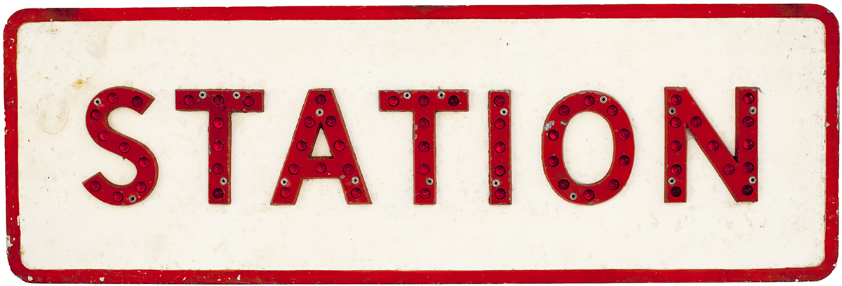 Cast aluminium road sign STATION, complete with all its red glass reflectors. In original
