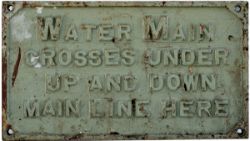 LNWR cast iron sign WATER MAIN CROSSES UNDER UP AND DOWN MAIN LINE HERE, measures 17in x 9in.