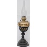 GWR waiting room table oil lamp with ornate cast iron base, brass reservoir and burner, and glass