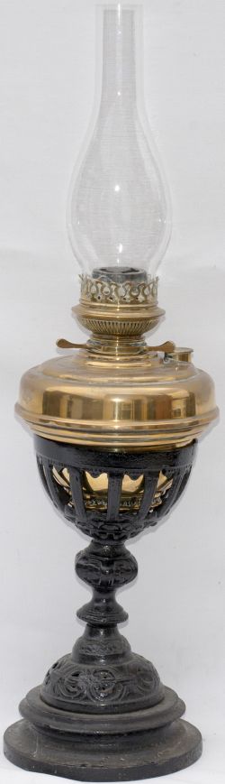 GWR waiting room table oil lamp with ornate cast iron base, brass reservoir and burner, and glass