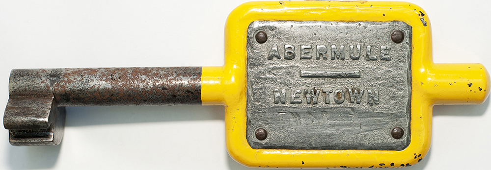 Tyers No9 single line steel key token ABERMULE-NEWTOWN, configuration D, has been repainted.