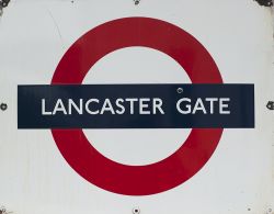 London Transport enamel roundel sign LANCASTER GATE. Measures 28in x 22in and is in good condition.