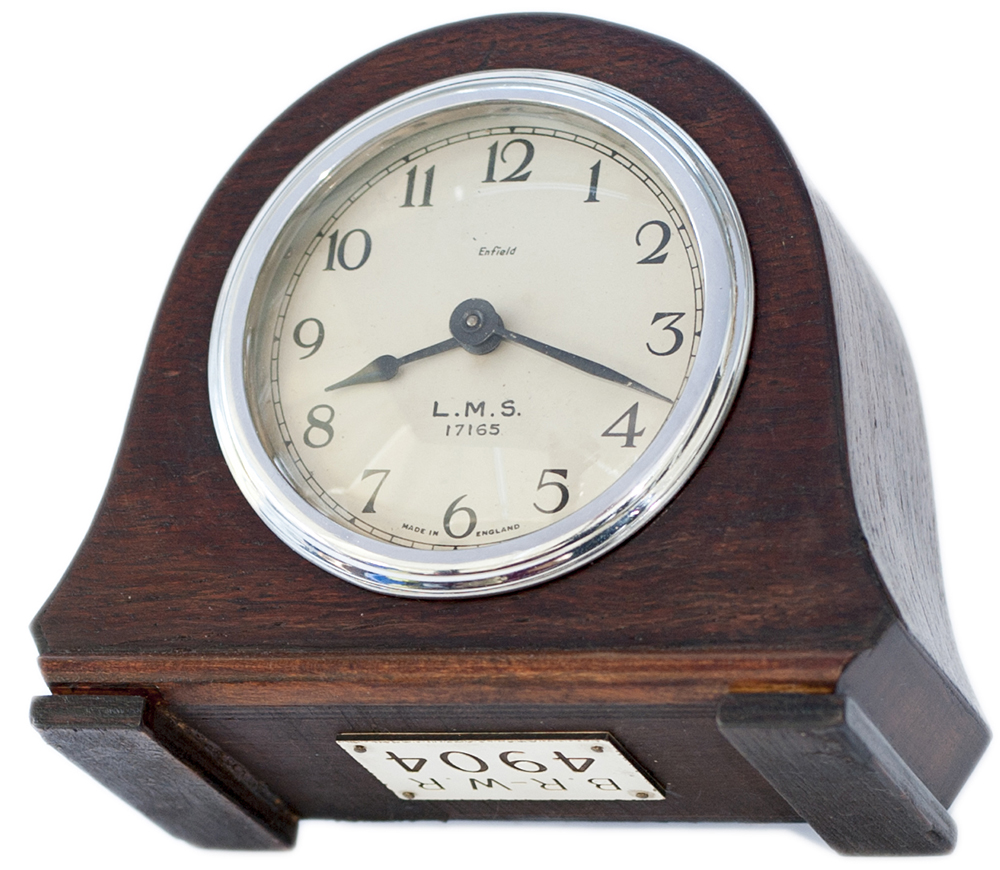LMS oak cased mantel railway clock. The 3.5in silvered dial is marked ENFIELD LMS 17165, the case