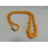 A simulated egg yolk amber graduated bead necklace