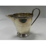 A Sheffield silver cream jug with Celtic style moulded rim band