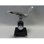 An Alberty quartz timepiece mounted to a marble plinth set with a white metal model of an eagle