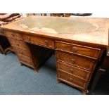 A 20th century reproduction yew wood finished kneehole desk in the 18th century style