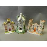 A group of Staffordshire castle and villa models including pastille burners and two money boxes (8)