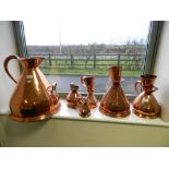A collection of copper haystack measures