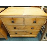 An early 20th century stripped pine chest of two short over two long drawers