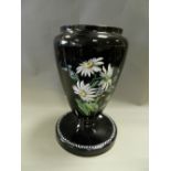 A French opalescent black glass vase enamelled with flowers and foliage.