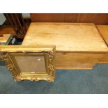A stripped pine hinged lid bedding box along with a Victorian style gesso picture frame (2)