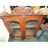 An Edwardian stained pine wall hanging glazed cabinet with four short interior drawers