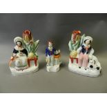 A group of Staffordshire figures including: rustic boy and girl beekeeper spill holders,