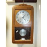 An inter-war period oak cased Vienna type wall clock