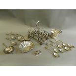 Four silver teaspoons together with a Peruvian white metal hammered dish, a silver tea strainer,