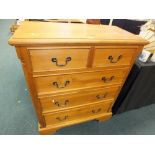 A modern pine chest of two short over three long drawers