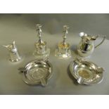 A pair of silver ashtrays each set with a commemorative coin together with a silver cream jug,