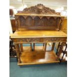 A late Victorian oak hunting lodge buffet table with two short drawers over an open shelf stretcher