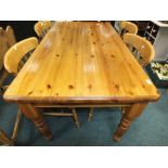 A modern pine rectangular kitchen table and four lath back kitchen chairs