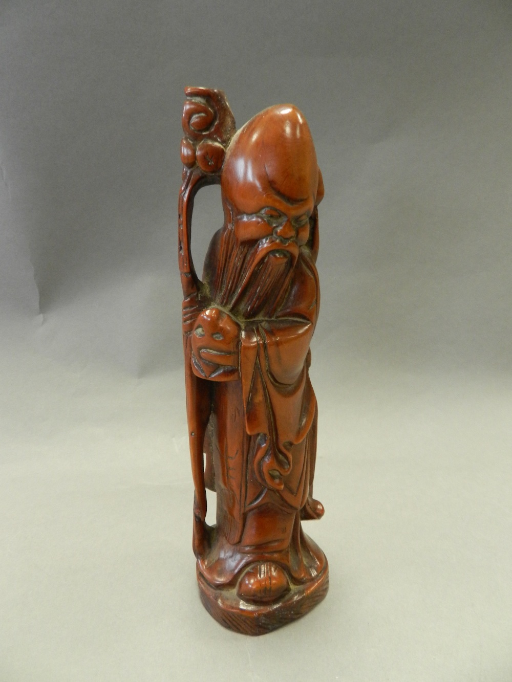 A Chinese rootwood figure of Shoulao, modelled standing and holding a staff and a peach, 18cm high. - Image 2 of 2