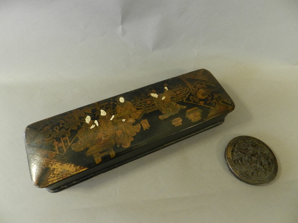 A Chinese taste papier mache box decorated with figures playing instruments on a terrace together