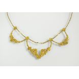 An early 20th century yellow metal and seed pearl necklace,