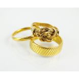 A 22ct gold wedding band, together with a further 22ct gold wedding band and an 18ct gold ring,