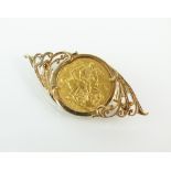 A sovereign set brooch, dated 1903, within 9ct gold scrolling mount, total weight 10.