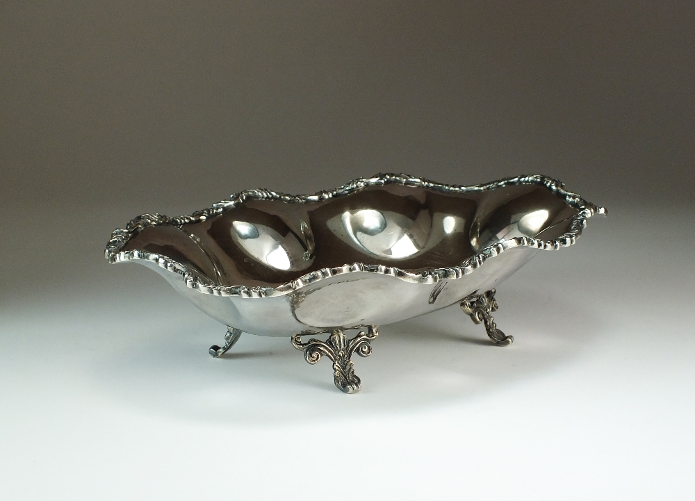 A Mexican Sterling silver bowl, of oval lobed form with scroll decorated border,