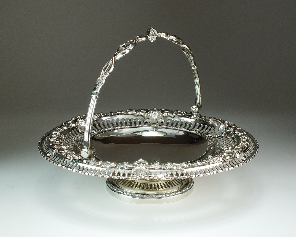 A Victorian silver swing handled cake basket, Henry Wilkinson & Co, London 1855,