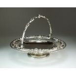 A Victorian silver swing handled cake basket, Henry Wilkinson & Co, London 1855,