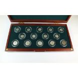 A cased set of fourteen ancient Roman silver coins, from Trajan to Gallienus,